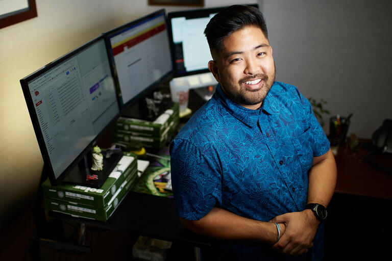 Portrait of Grant Kurosu, web communications specialist in office.